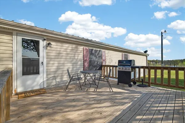 a view of a patio with a table chairs and barbeque grill