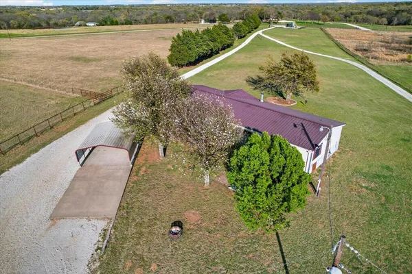 a view of a swimming pool with a yard and outdoor seating