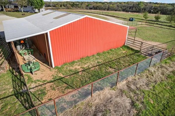 an aerial view of a residential houses with outdoor space