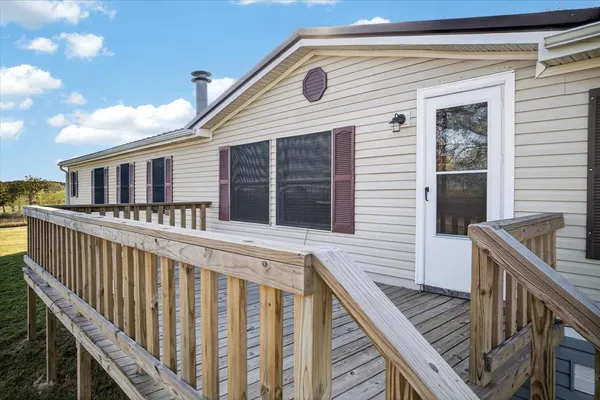 a view of a house with wooden deck