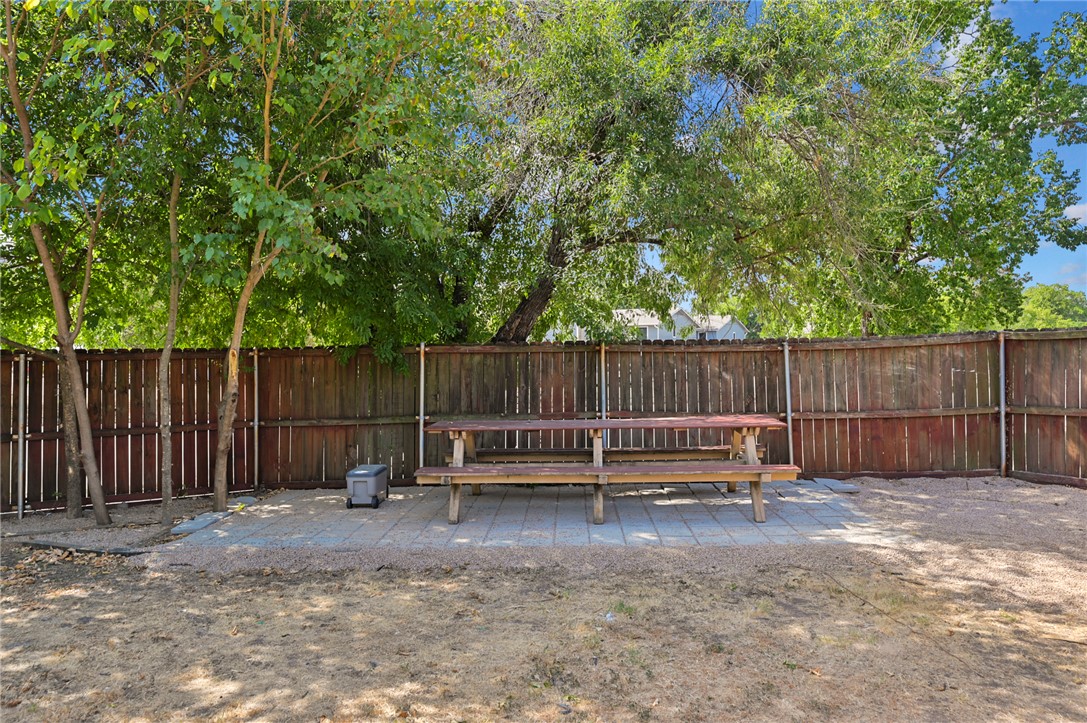 1537 Pine Ridge Drive, Unit D College Station, TX 77840 - Photo 12 of 12 a backyard of a house with barbeque oven and trees