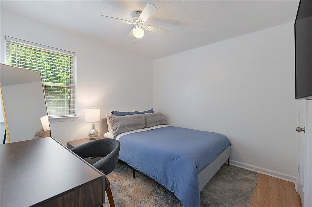 1537 Pine Ridge Drive, Unit D College Station, TX 77840 - Photo 7 of 12 a bedroom with a bed and a window