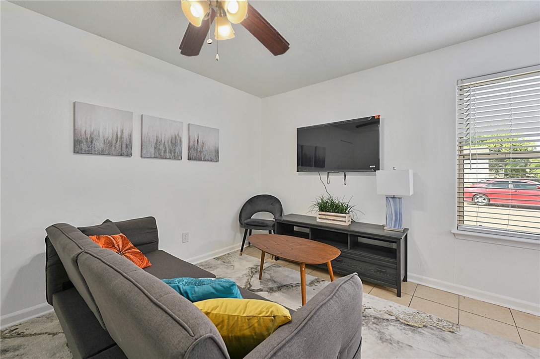 1537 Pine Ridge Drive, Unit D College Station, TX 77840 - Photo 8 of 12 a living room with furniture and a flat screen tv