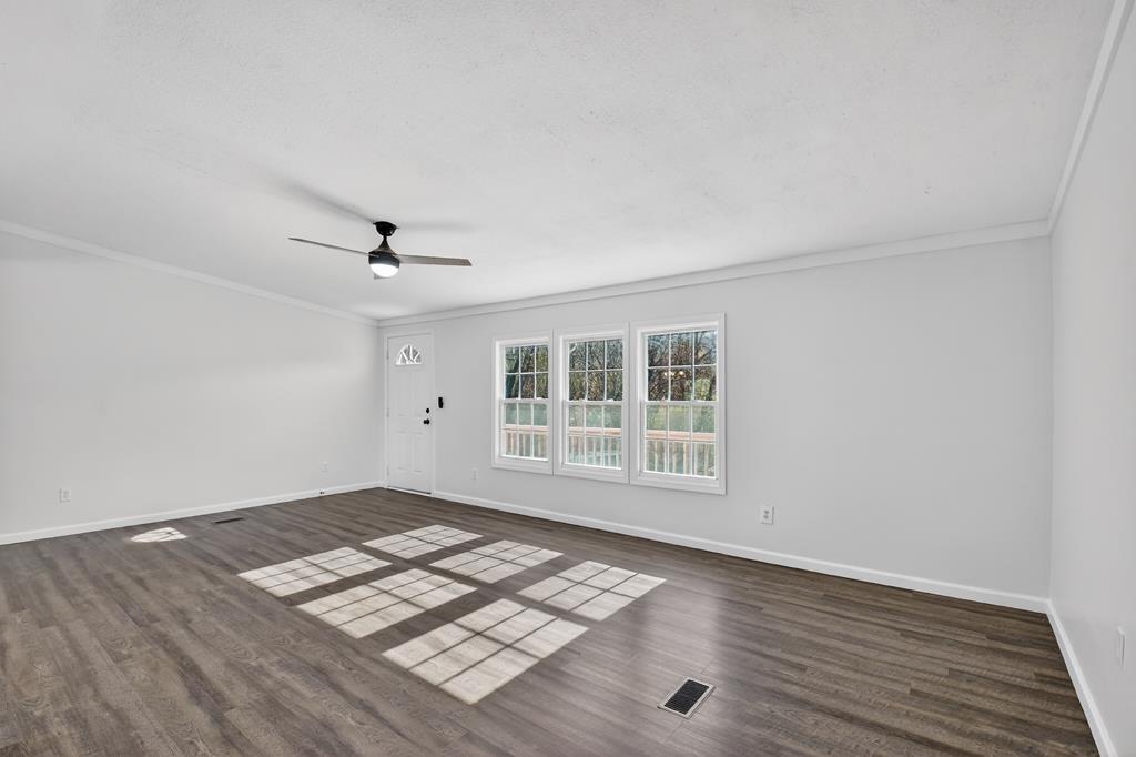 10967 Old Highway 76 Morganton, GA 30560 - Photo 12 of 31 an empty room with wooden floor fan and windows