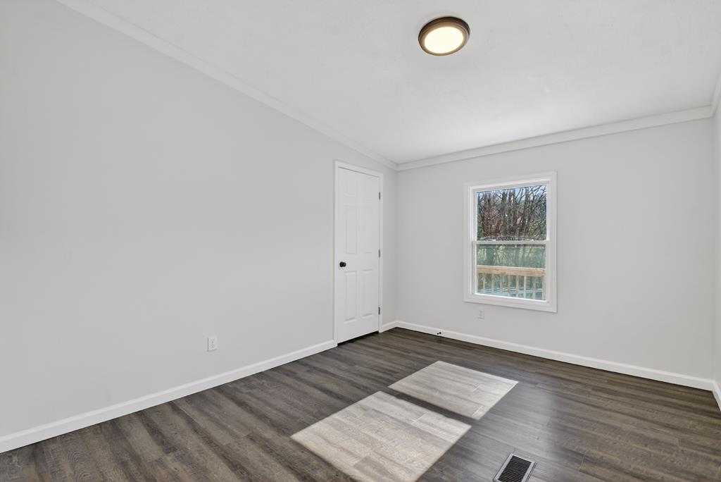 10967 Old Highway 76 Morganton, GA 30560 - Photo 15 of 31 an empty room with wooden floor and windows