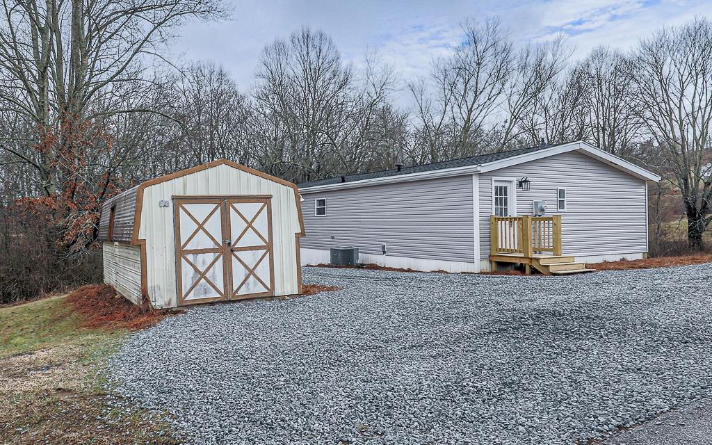 10967 Old Highway 76 Morganton, GA 30560 - Photo 22 of 31 a view of a house with a yard and garage