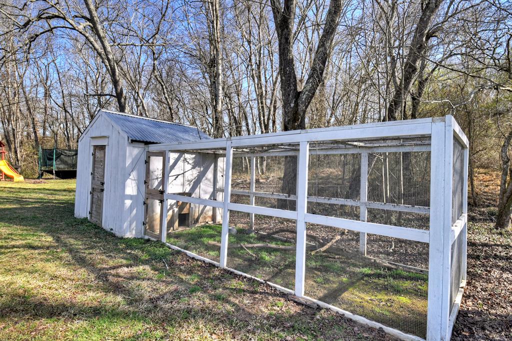 10967 Old Highway 76 Morganton, GA 30560 - Photo 23 of 31 a view of a house with a large window and wooden fence