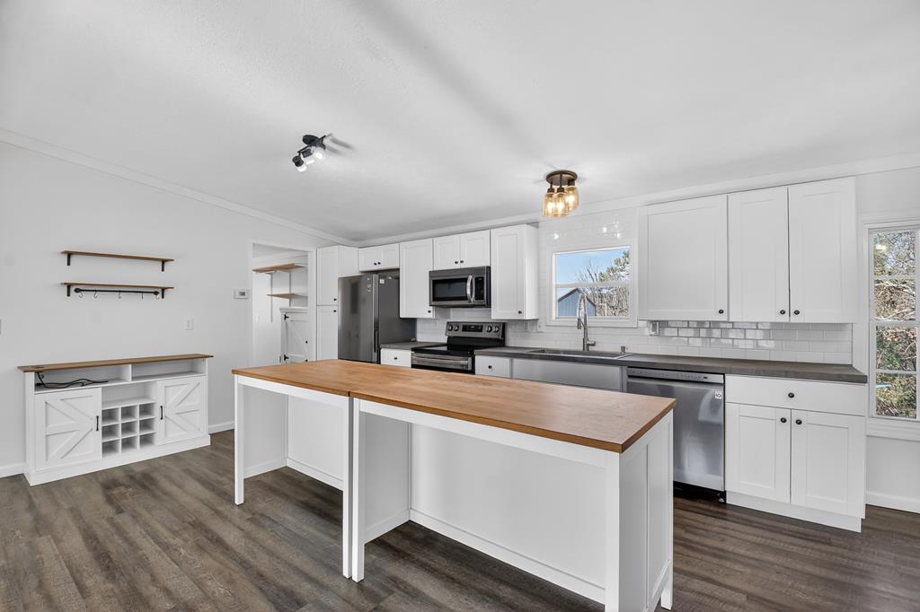 10967 Old Highway 76 Morganton, GA 30560 - Photo 6 of 31 a large white kitchen with a sink and a stove top oven
