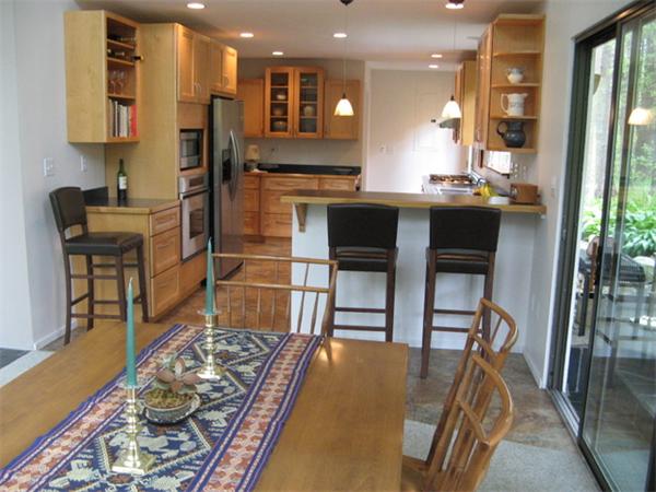 120 Still River Road Harvard, MA 01451 - Photo 6 of 22 a kitchen with kitchen island wooden cabinets and refrigerator