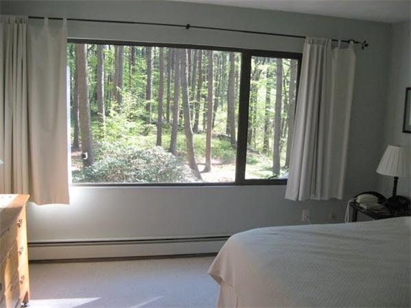 120 Still River Road Harvard, MA 01451 - Photo 8 of 22 a bed sitting in a bedroom next to a window