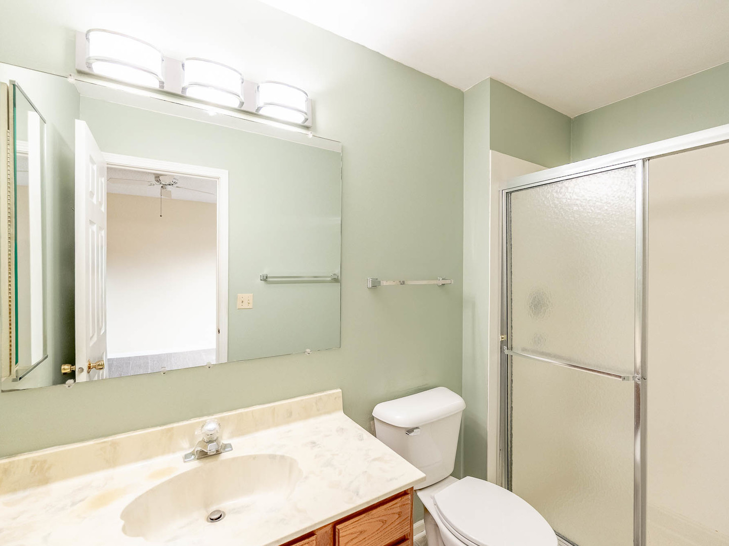 4 Candlewood Court Cary, IL 60013 - Photo 14 of 21 a bathroom with a sink toilet a mirror and shower