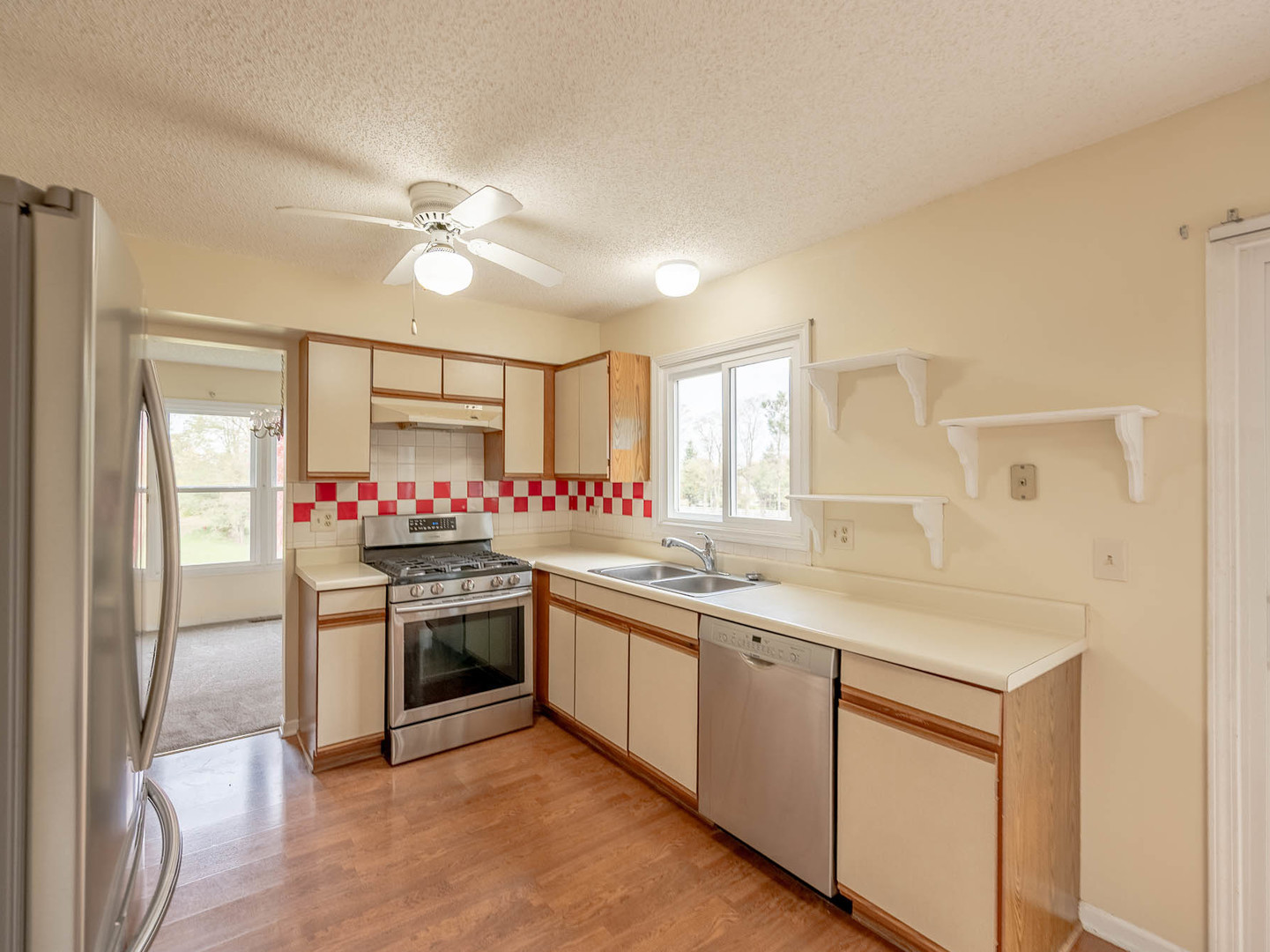 4 Candlewood Court Cary, IL 60013 - Photo 5 of 21 a kitchen with stainless steel appliances granite countertop a sink and a stove