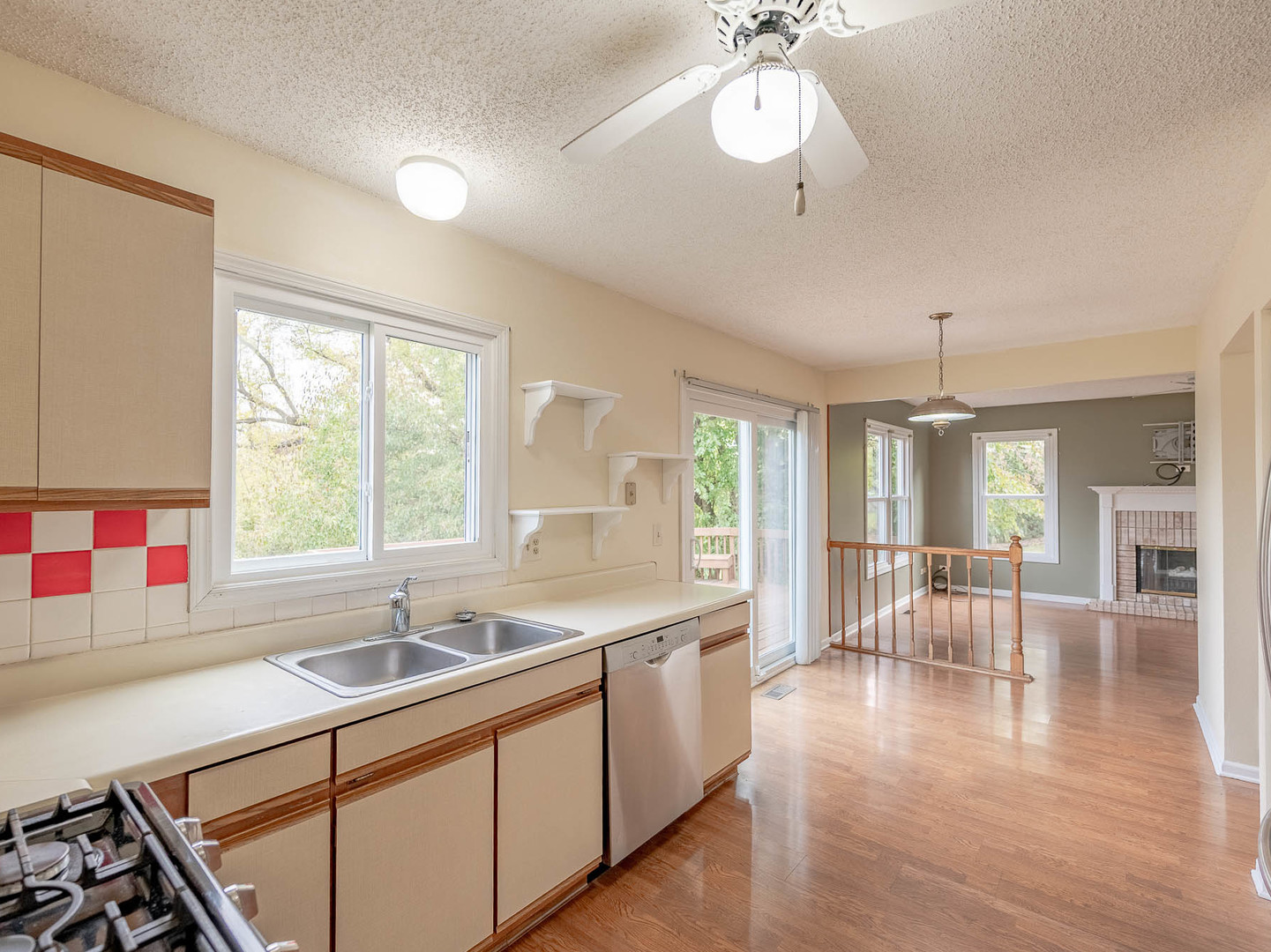 4 Candlewood Court Cary, IL 60013 - Photo 7 of 21 a kitchen with a sink stove and wooden floor