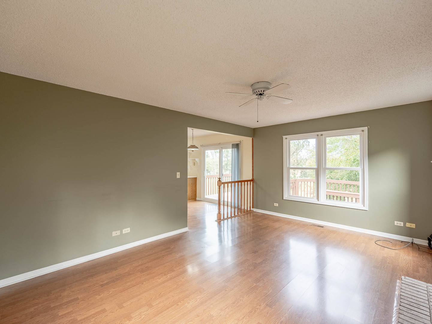 4 Candlewood Court Cary, IL 60013 - Photo 9 of 21 an empty room with wooden floor and windows