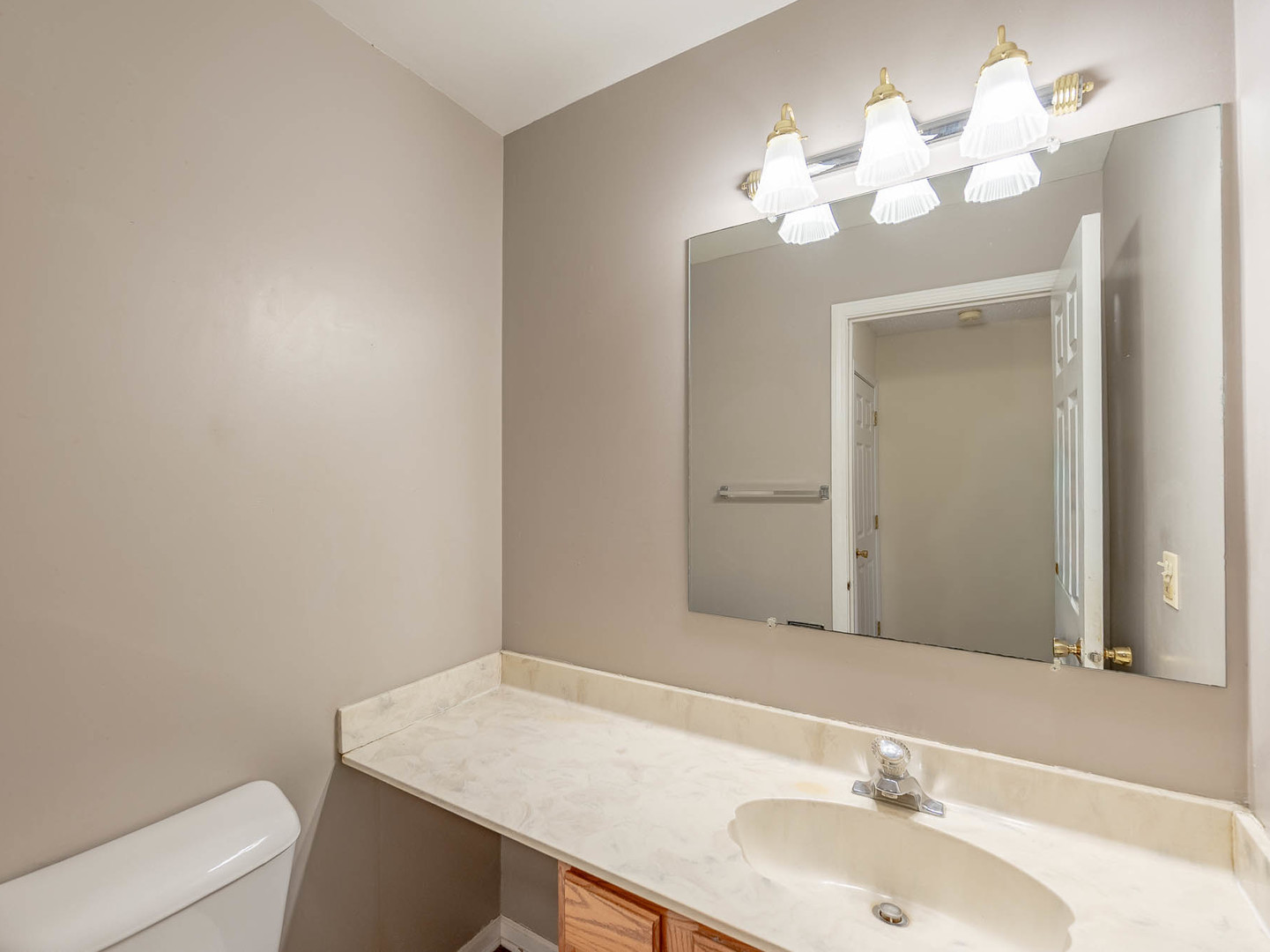 4 Candlewood Court Cary, IL 60013 - Photo 10 of 21 a bathroom with a sink vanity and a mirror