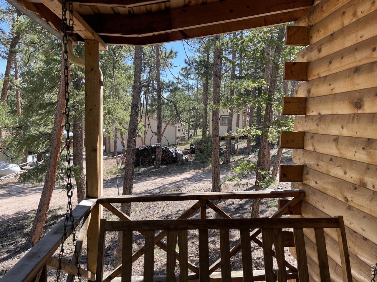 35 Robin Path Red Feather Lakes, CO 80545 - Photo 17 of 25 Covered front porch & swing + picnic table.