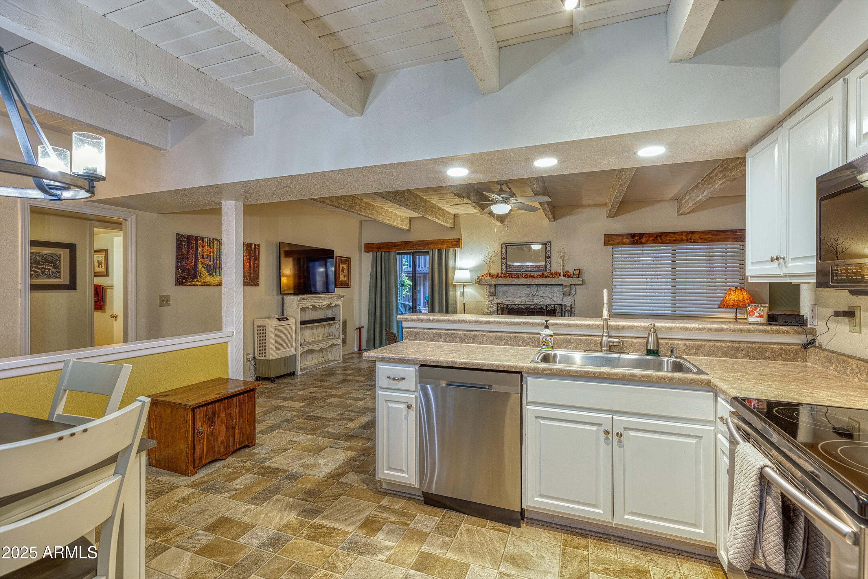 2641 Sports Village Loop, Unit 2 Pinetop, AZ 85935 - Photo 14 of 33 a kitchen with a sink and cabinets