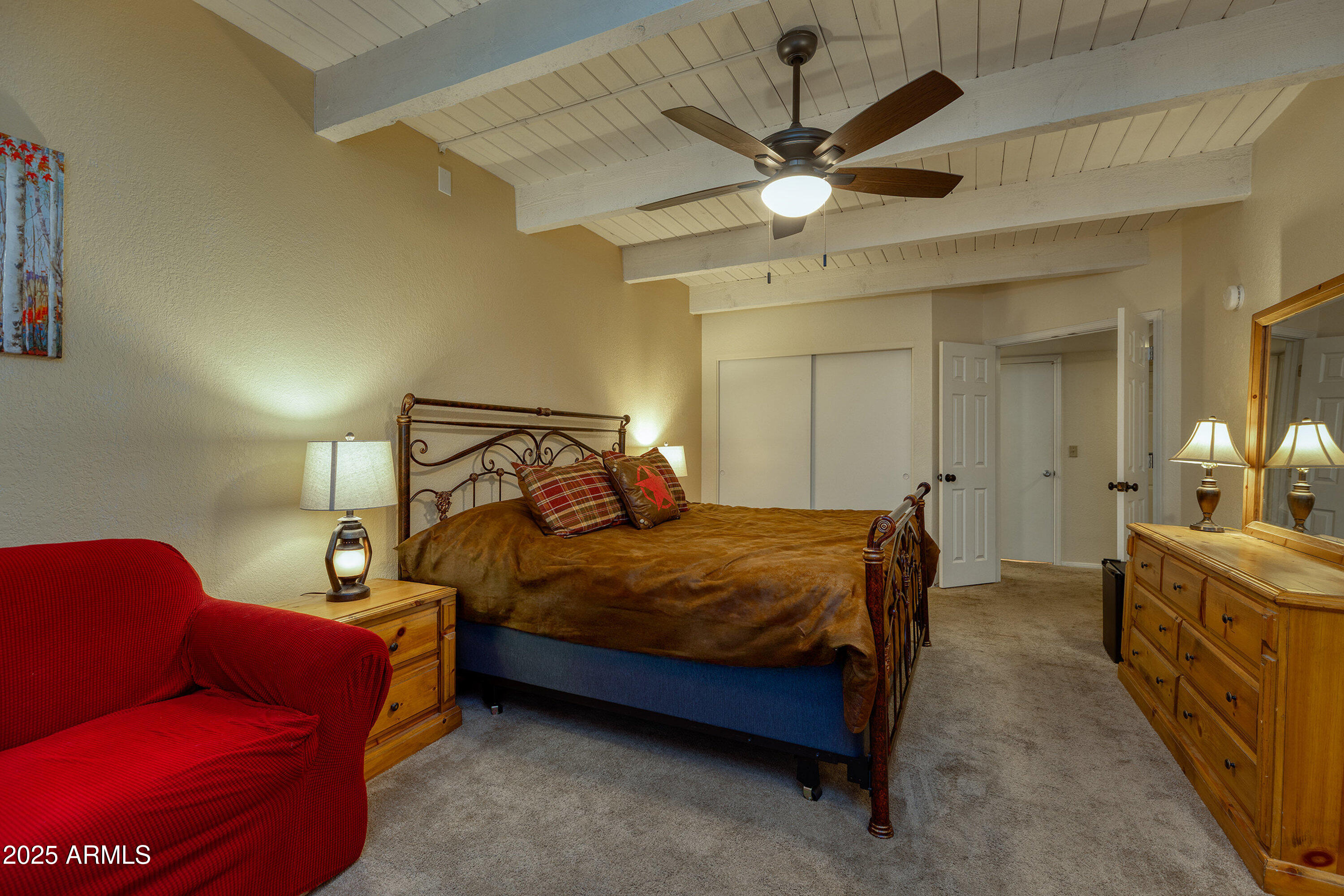 2641 Sports Village Loop, Unit 2 Pinetop, AZ 85935 - Photo 18 of 33 a bedroom with a bed and a chandelier