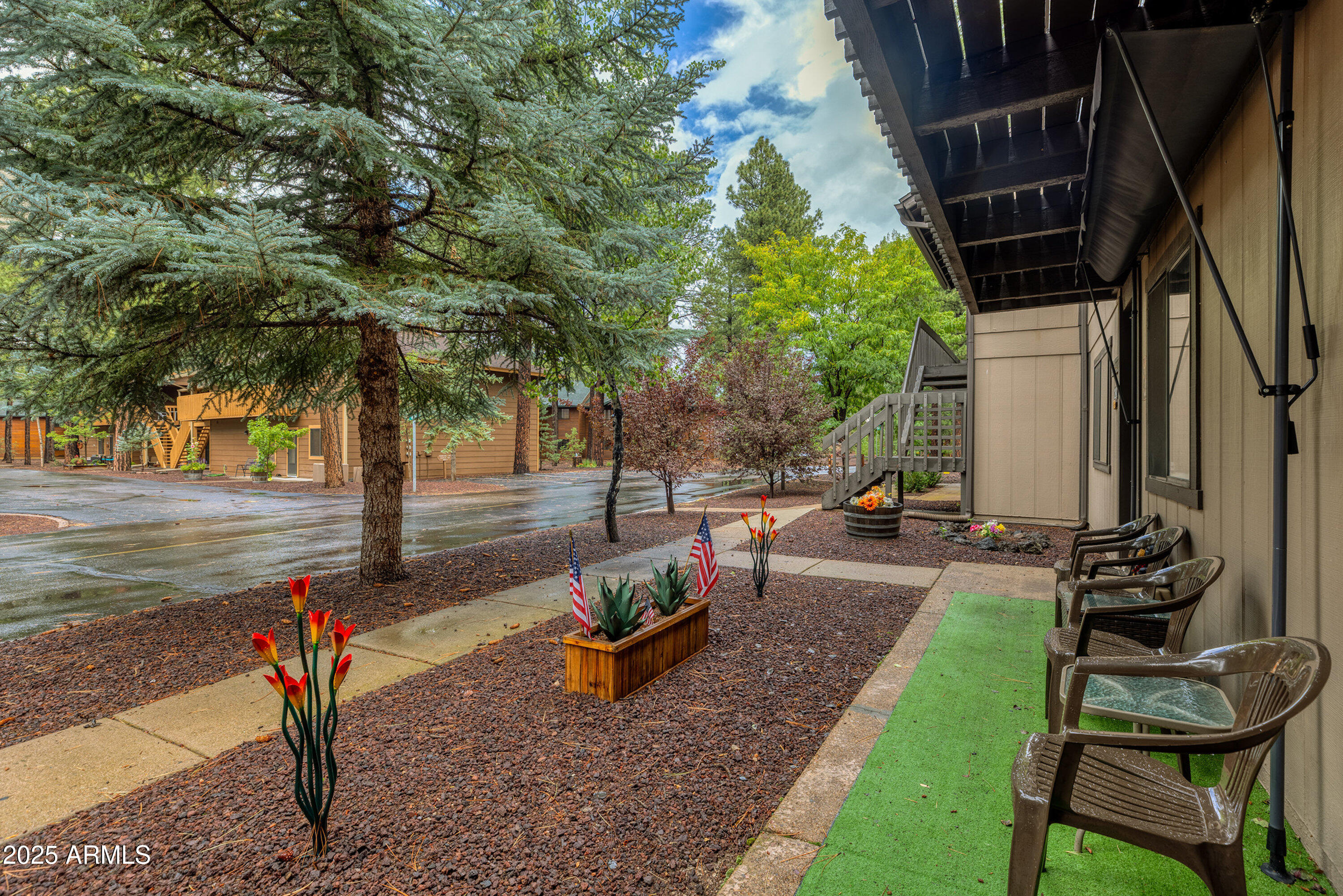 2641 Sports Village Loop, Unit 2 Pinetop, AZ 85935 - Photo 2 of 33 a backyard of a house with table and chairs