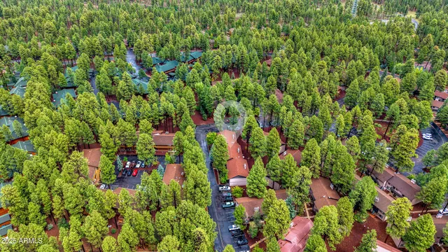 an aerial view of a house with yard and seating space