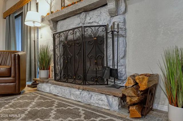 a living room with furniture a fireplace and a flat screen tv