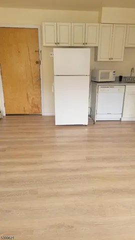 a view of storage and utility room with wooden floor