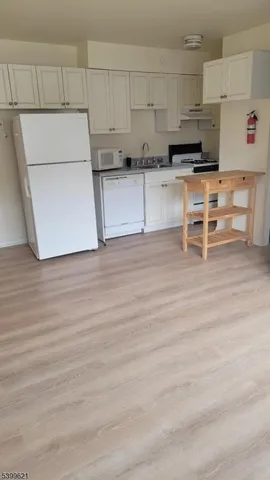 a kitchen with stainless steel appliances wooden cabinets and a table