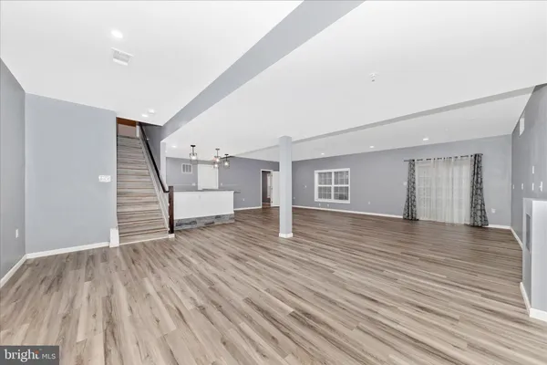 a view of an entryway with wooden floor