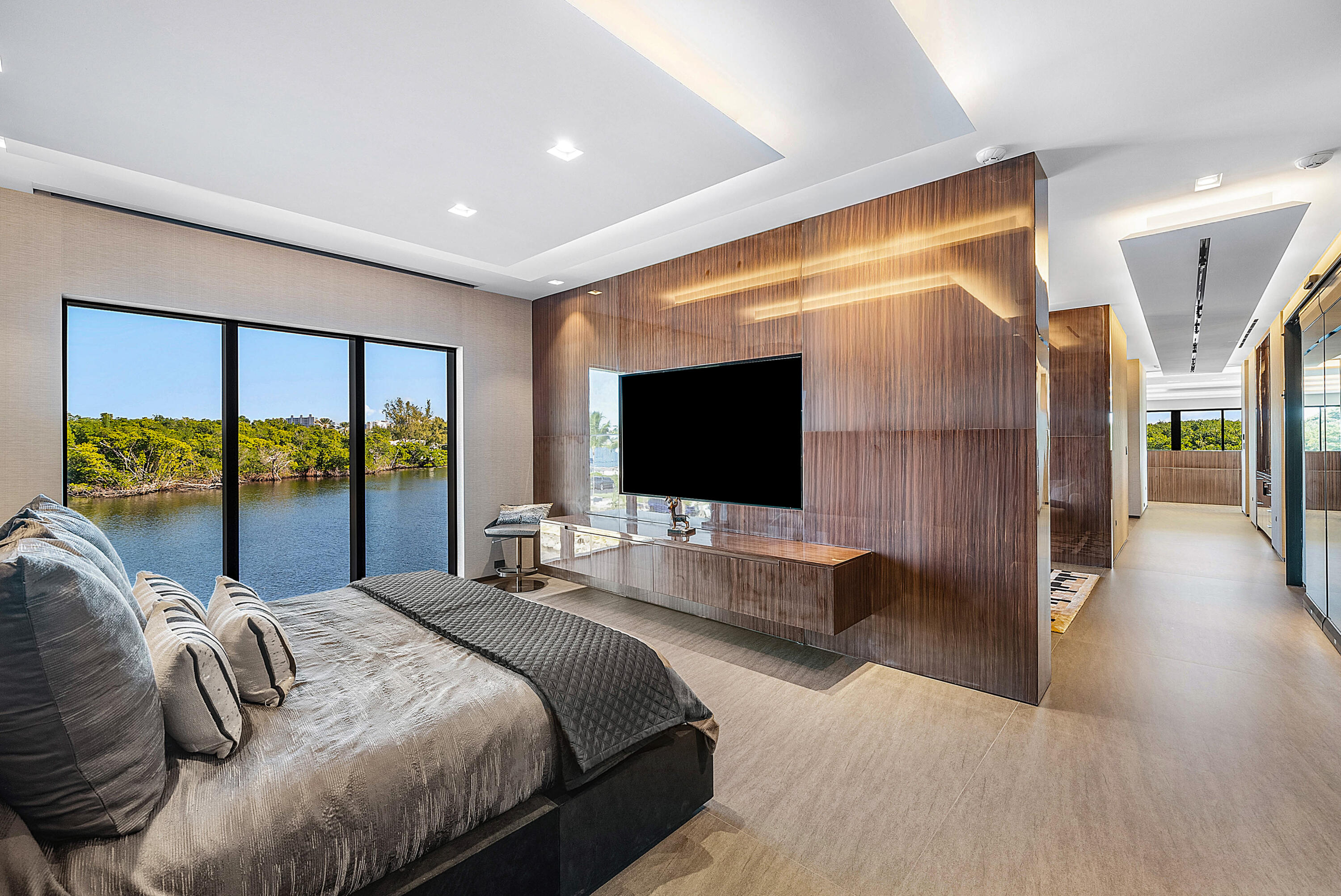 2934 Northeast 8th Avenue Boca Raton, FL 33431 - Photo 80 of 116 a bedroom with a large bed and a flat tv screen next to a large window
