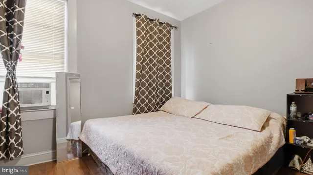 a bedroom with a bed and a window