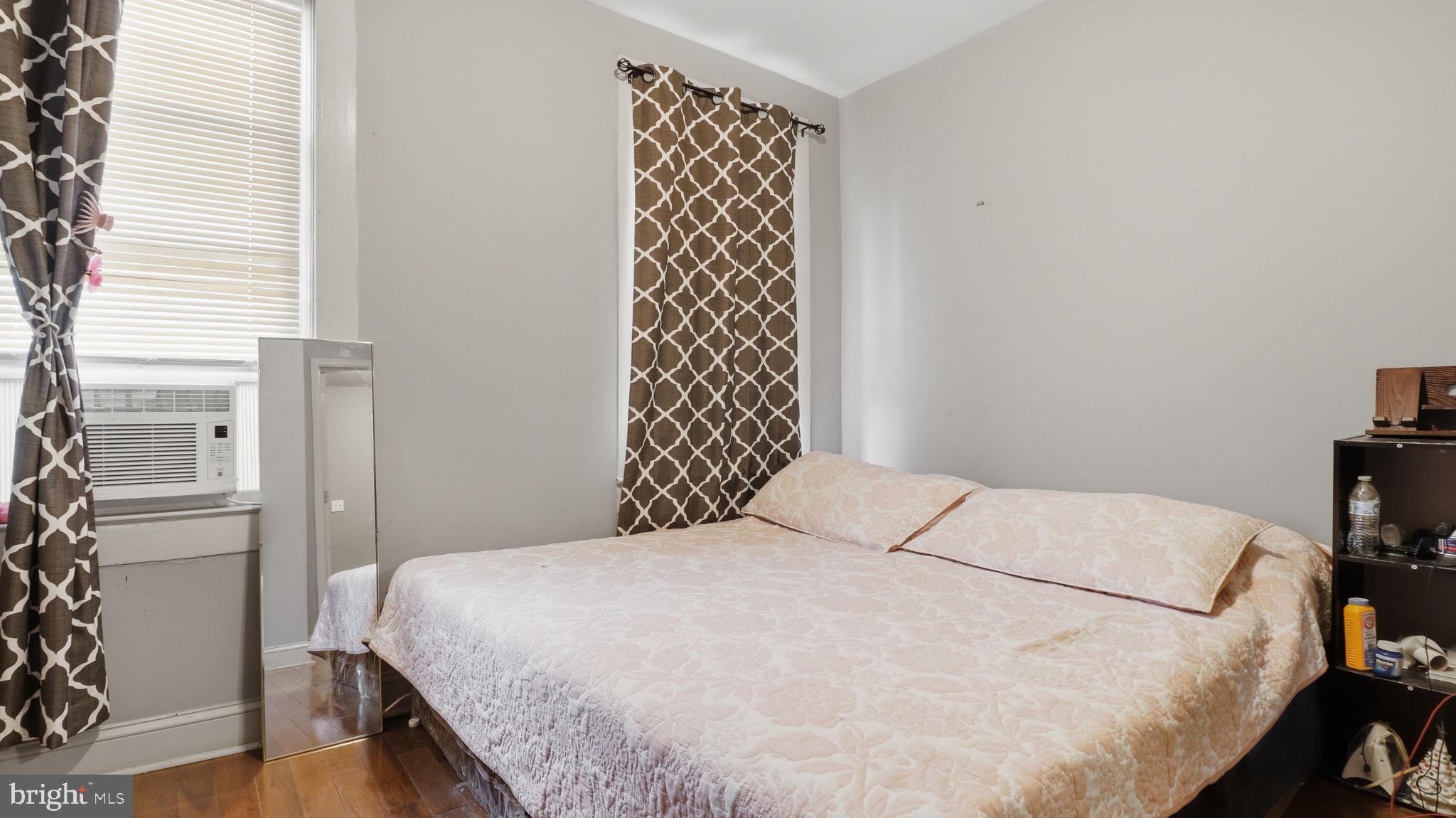 211 Fagley Street Baltimore, MD 21224 - Photo 11 of 16 a bedroom with a bed and a cabinets