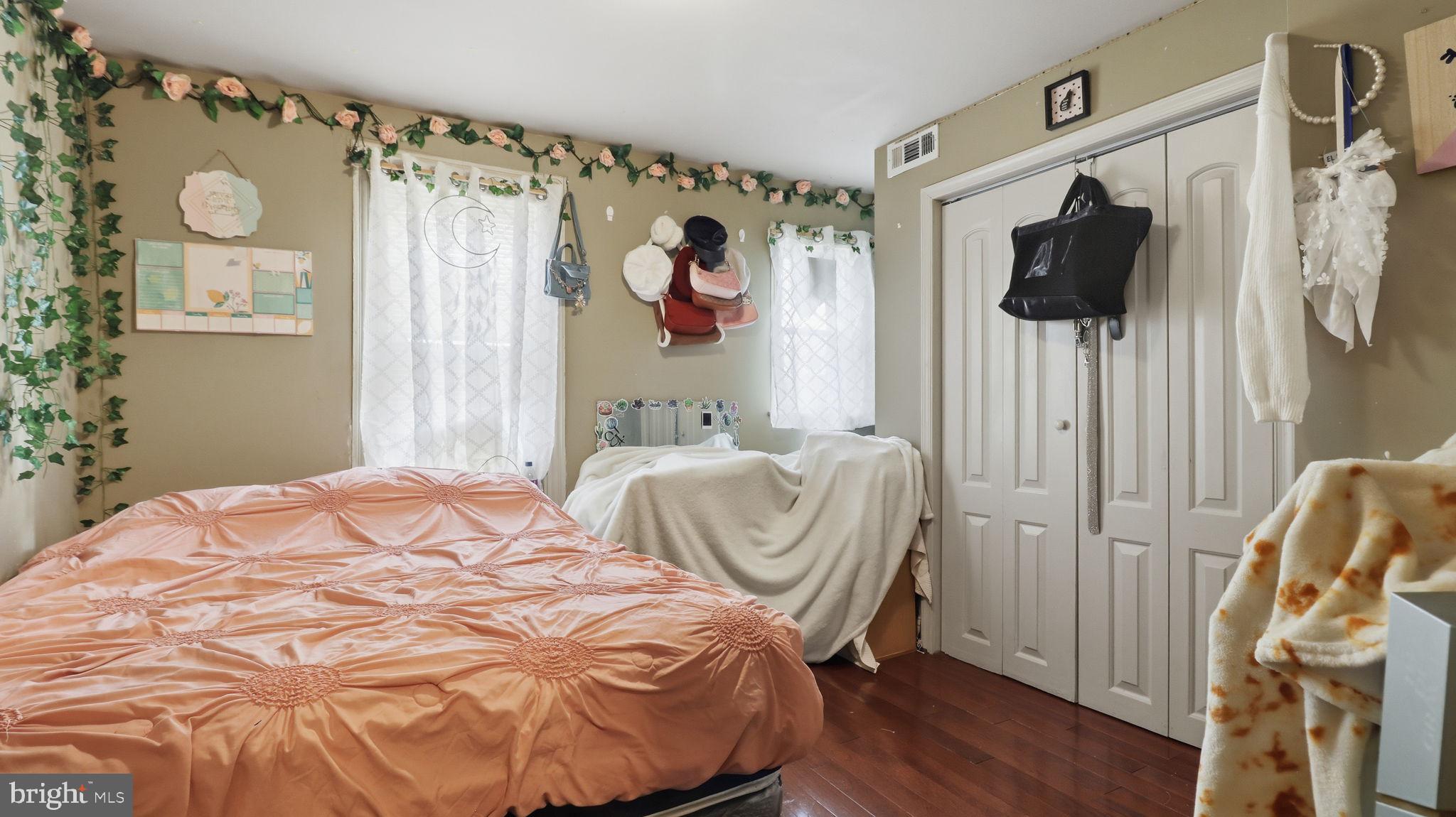 211 Fagley Street Baltimore, MD 21224 - Photo 14 of 16 a bedroom with a bed and flat screen tv