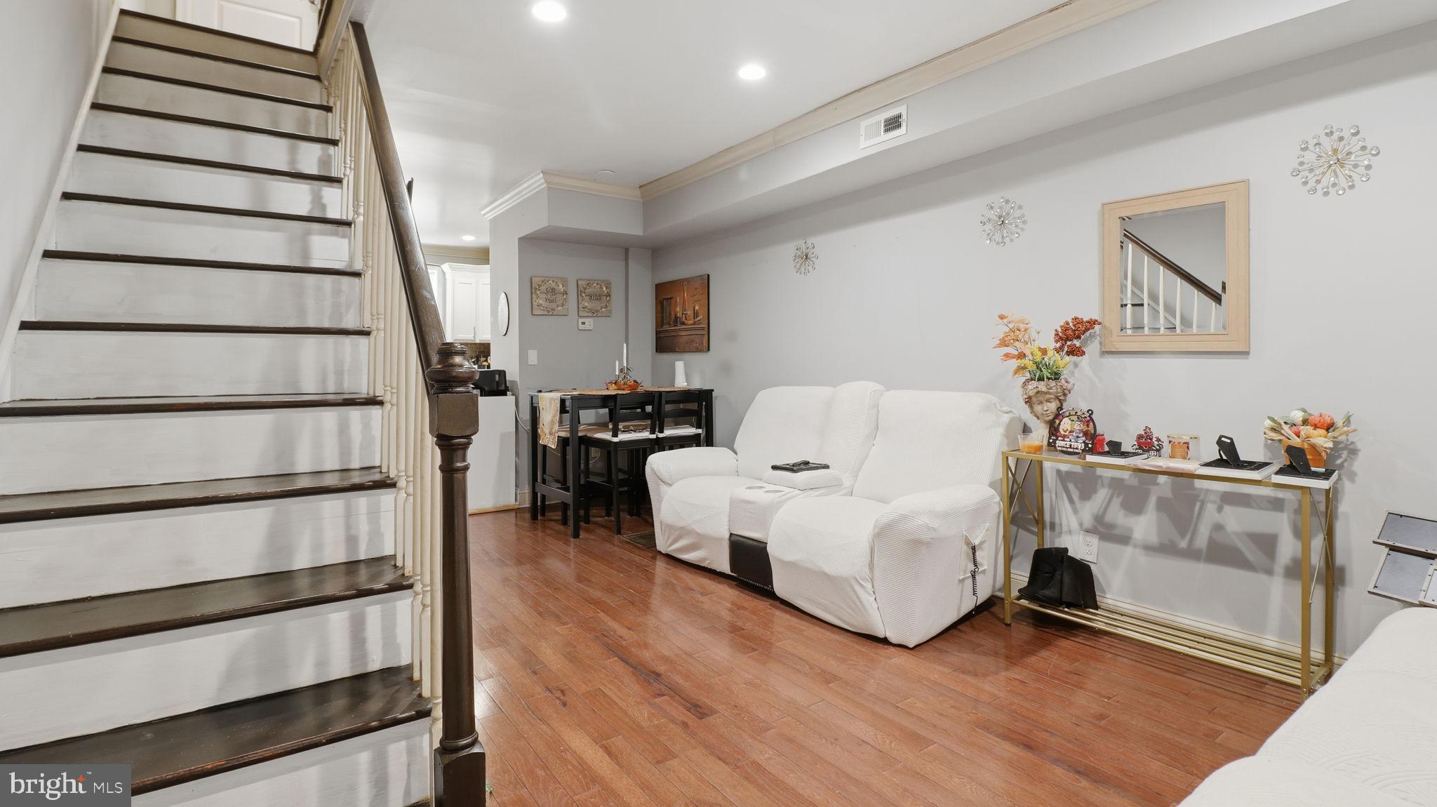 211 Fagley Street Baltimore, MD 21224 - Photo 6 of 16 a living room with furniture and a wooden floor