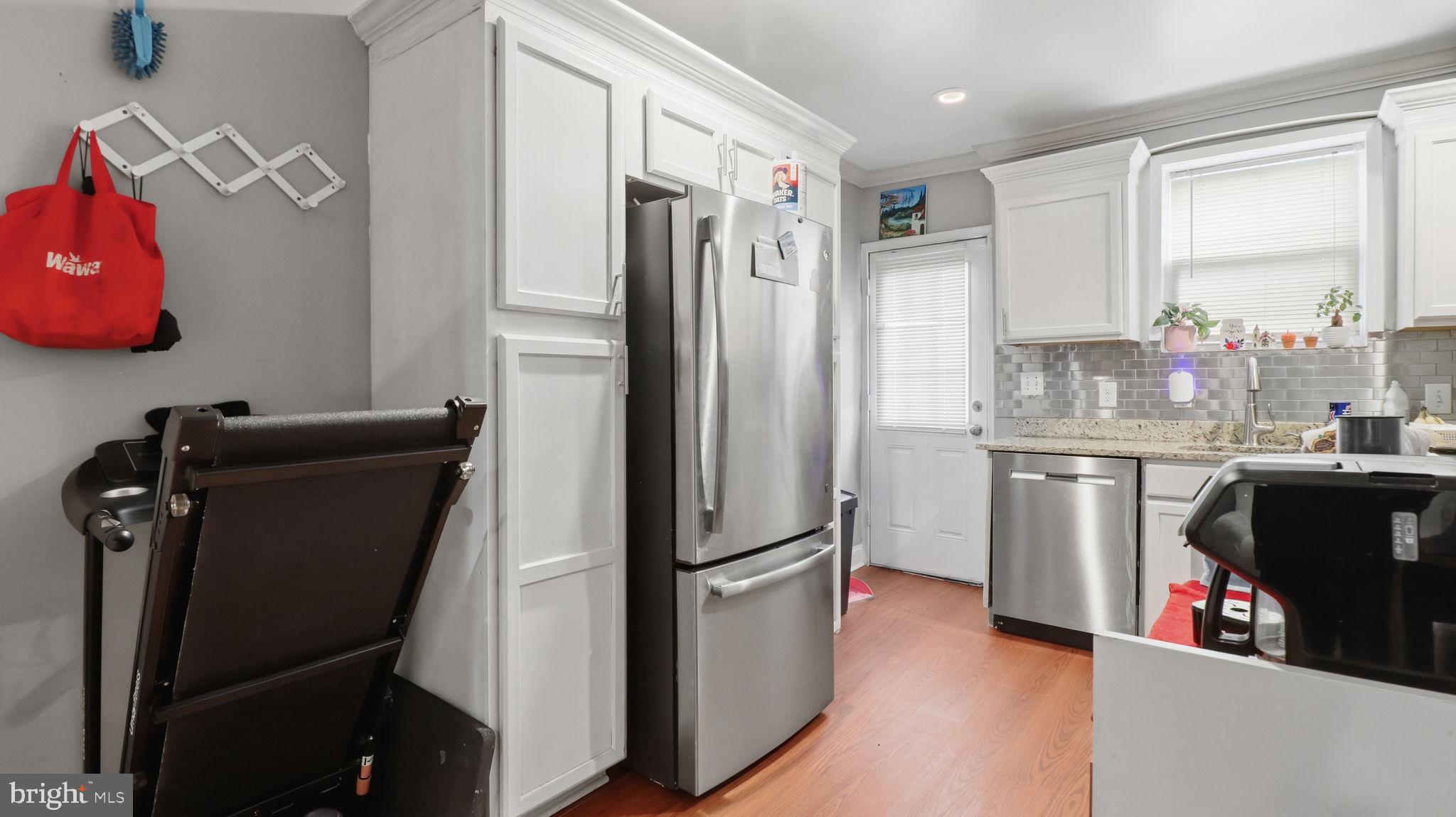 211 Fagley Street Baltimore, MD 21224 - Photo 8 of 16 a kitchen with a refrigerator and a sink