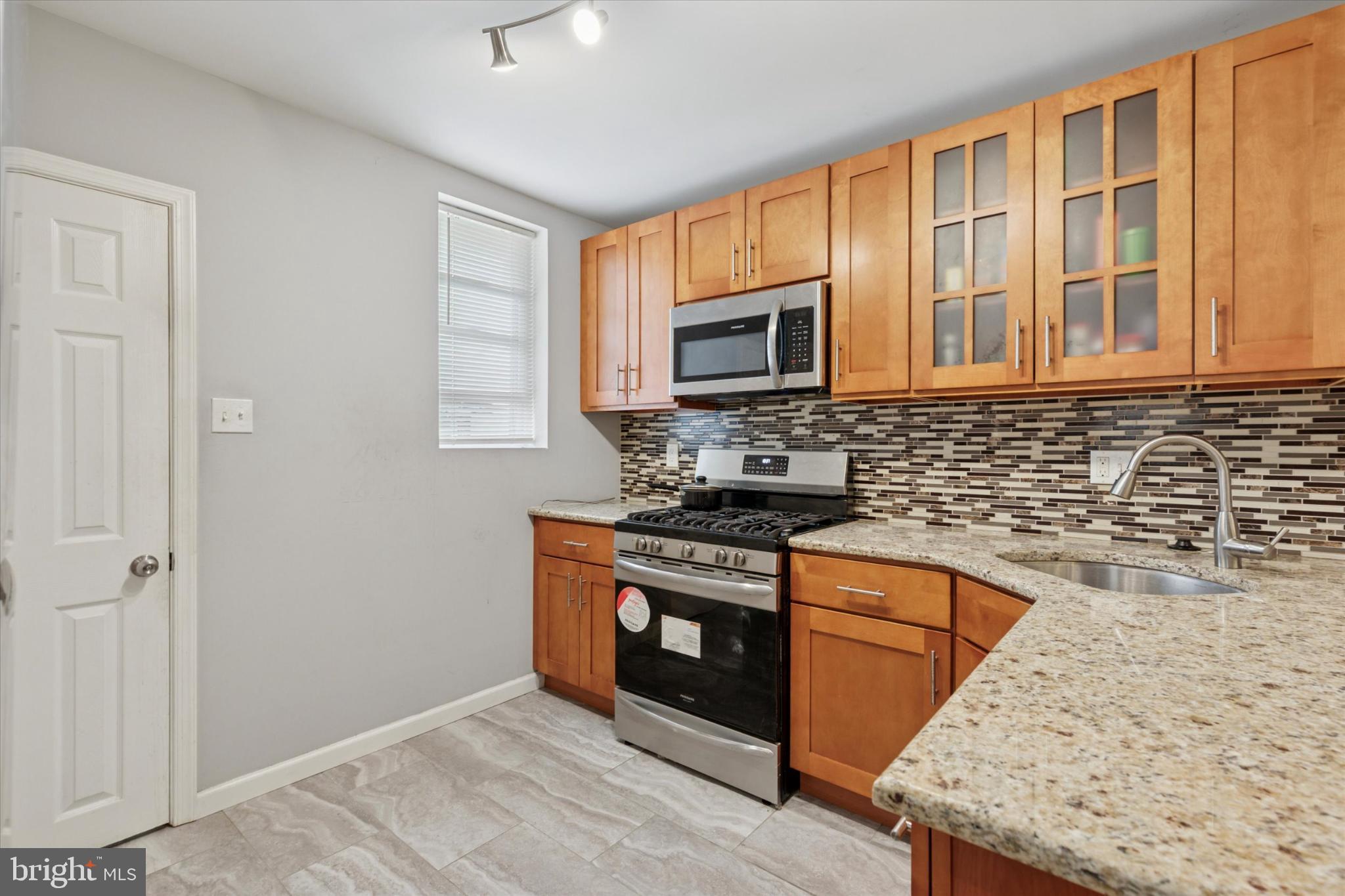 1815 Elston Street Philadelphia, PA 19126 - Photo 5 of 14 Modern kitchen with sleek cabinetry and tile.