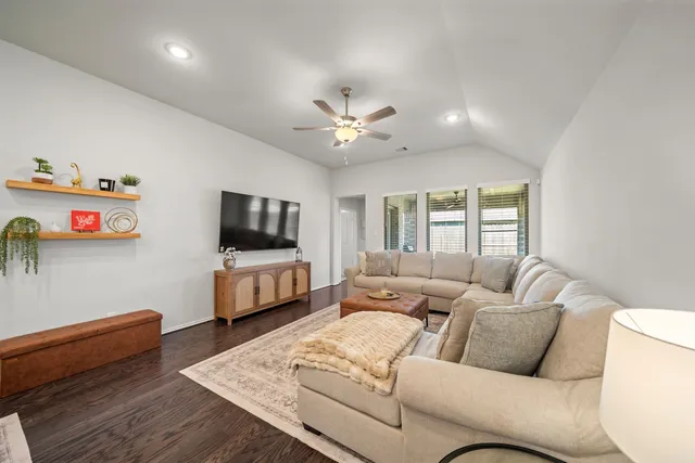 a living room with furniture and a flat screen tv