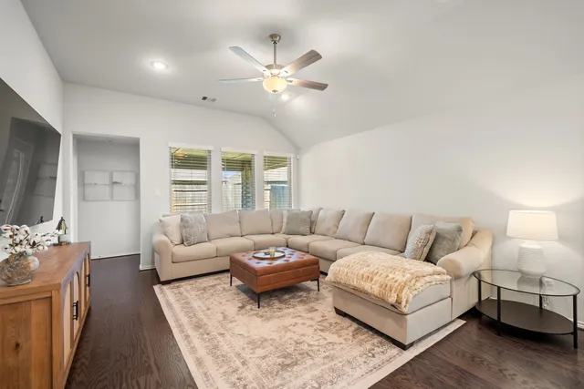 a living room with furniture and a large window
