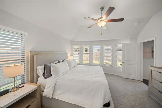 a bedroom with a large bed and a window