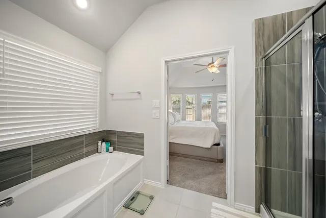 a bathroom with a tub shower and sink