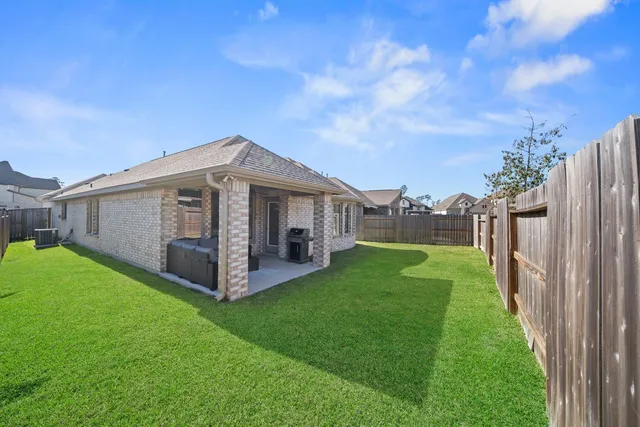a view of a house with backyard and porch