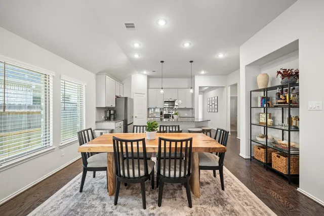 a dining room with furniture and window