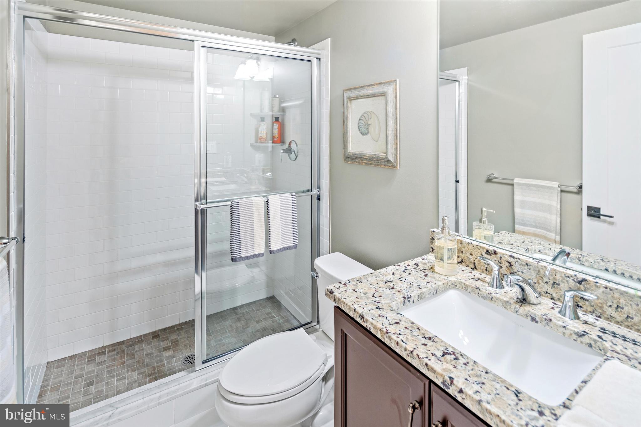 56 Umbrell Drive Eagleville, PA 19403 - Photo 28 of 28 a bathroom with a granite countertop sink toilet and shower