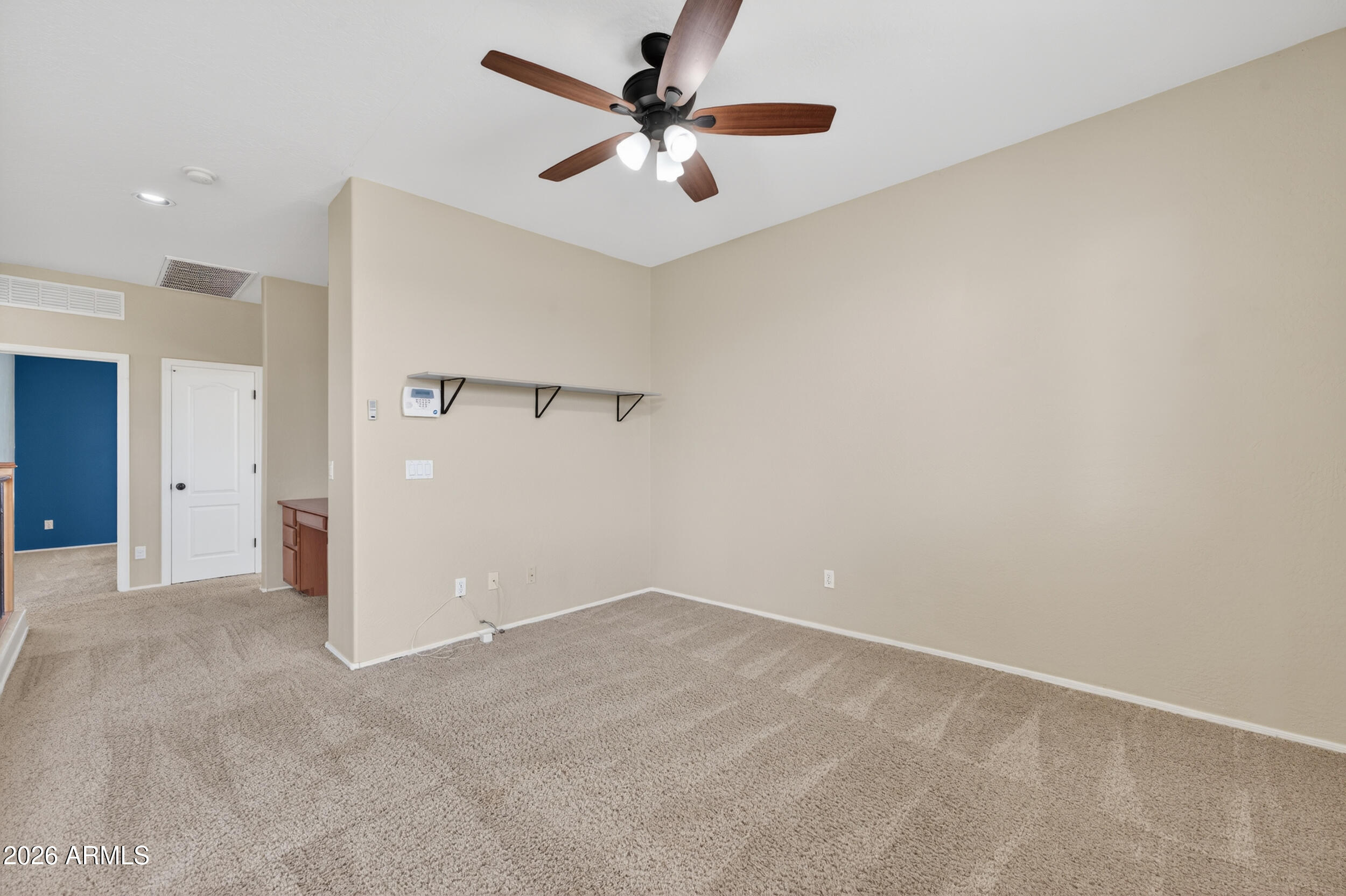 4199 North 154th Drive Goodyear, AZ 85395 - Photo 15 of 17 an empty room with closet and a ceiling fan