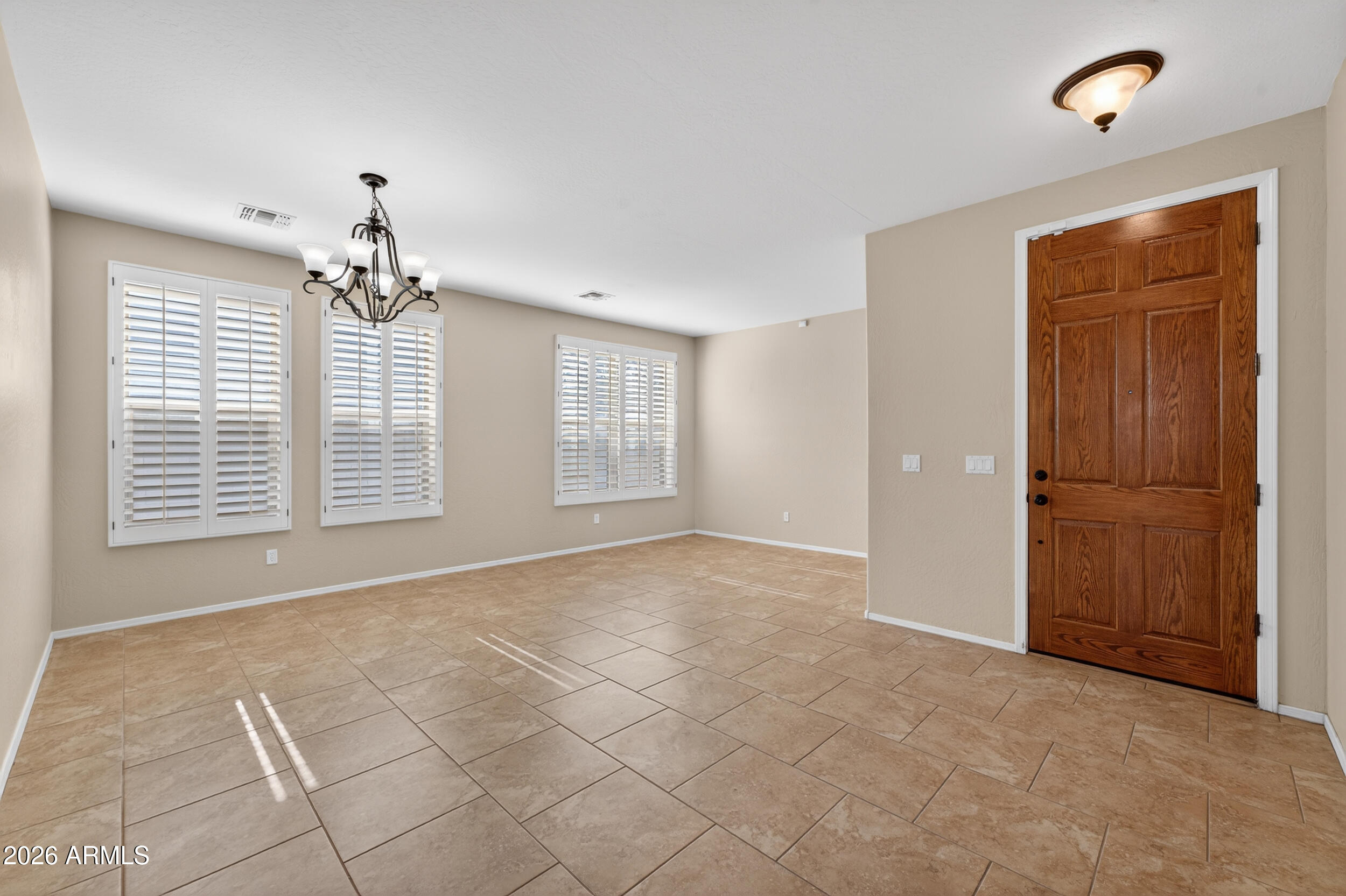 4199 North 154th Drive Goodyear, AZ 85395 - Photo 5 of 17 a view of an empty room with a window
