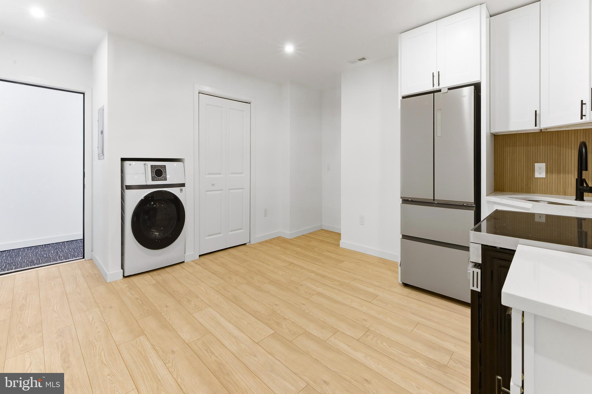 201 Broadway, Unit RES A Westville, NJ 08093 - Photo 7 of 11 a kitchen with a refrigerator and microwave