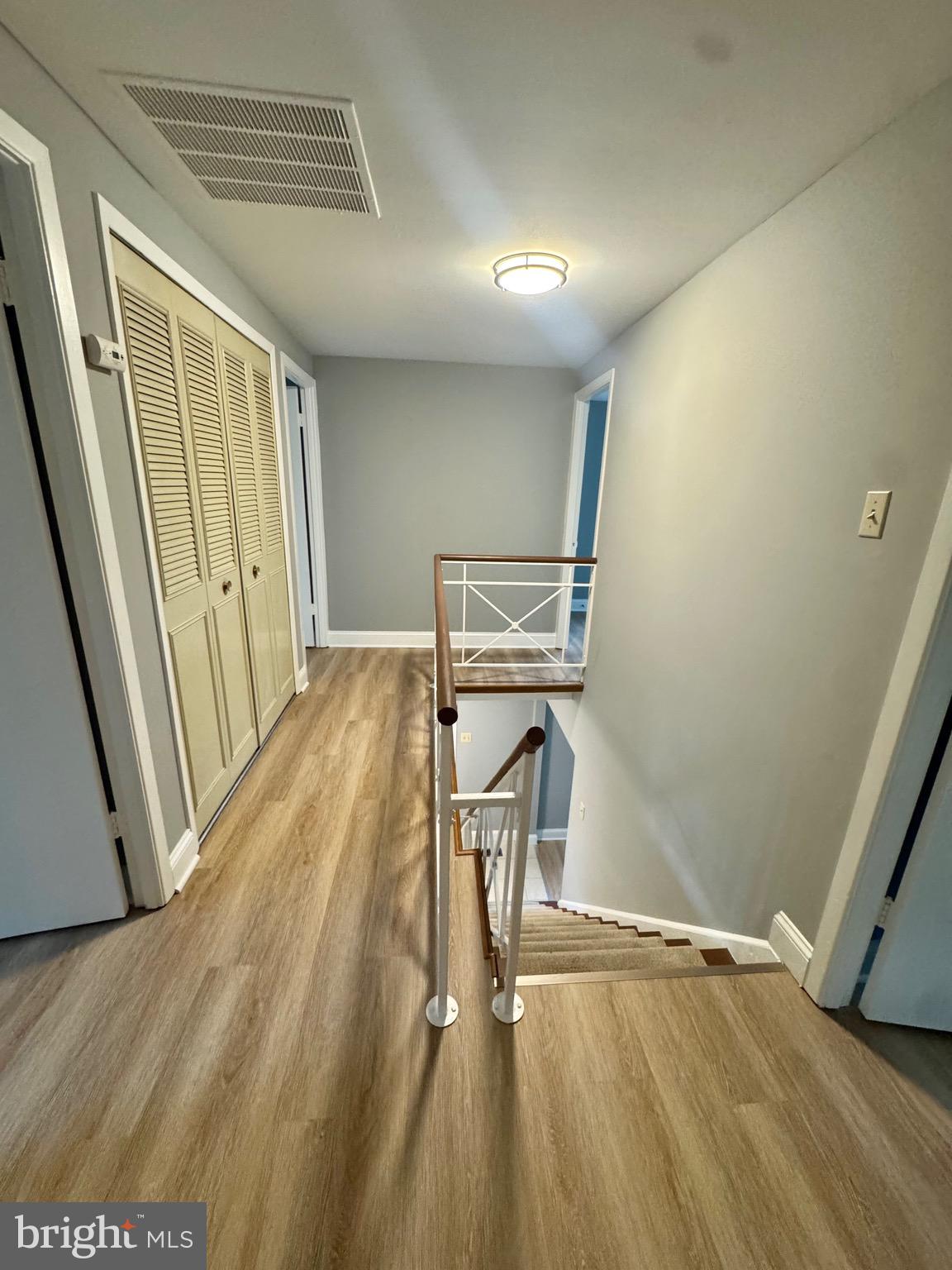 4908 Rocky Spring Lane Bowie, MD 20715 - Photo 17 of 36 a view of a room with wooden floor and staircase