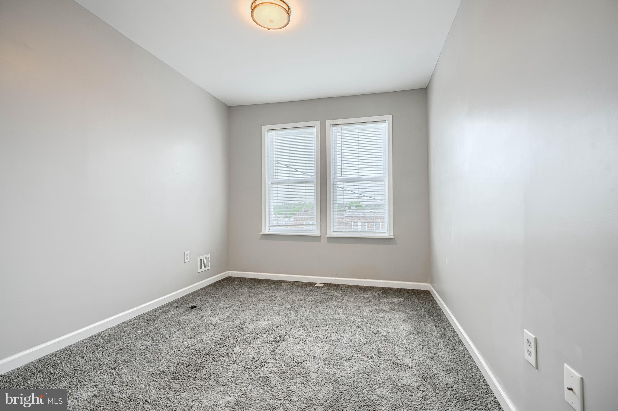 1702 East 32nd Street Baltimore, MD 21218 - Photo 16 of 38 an empty room with a window