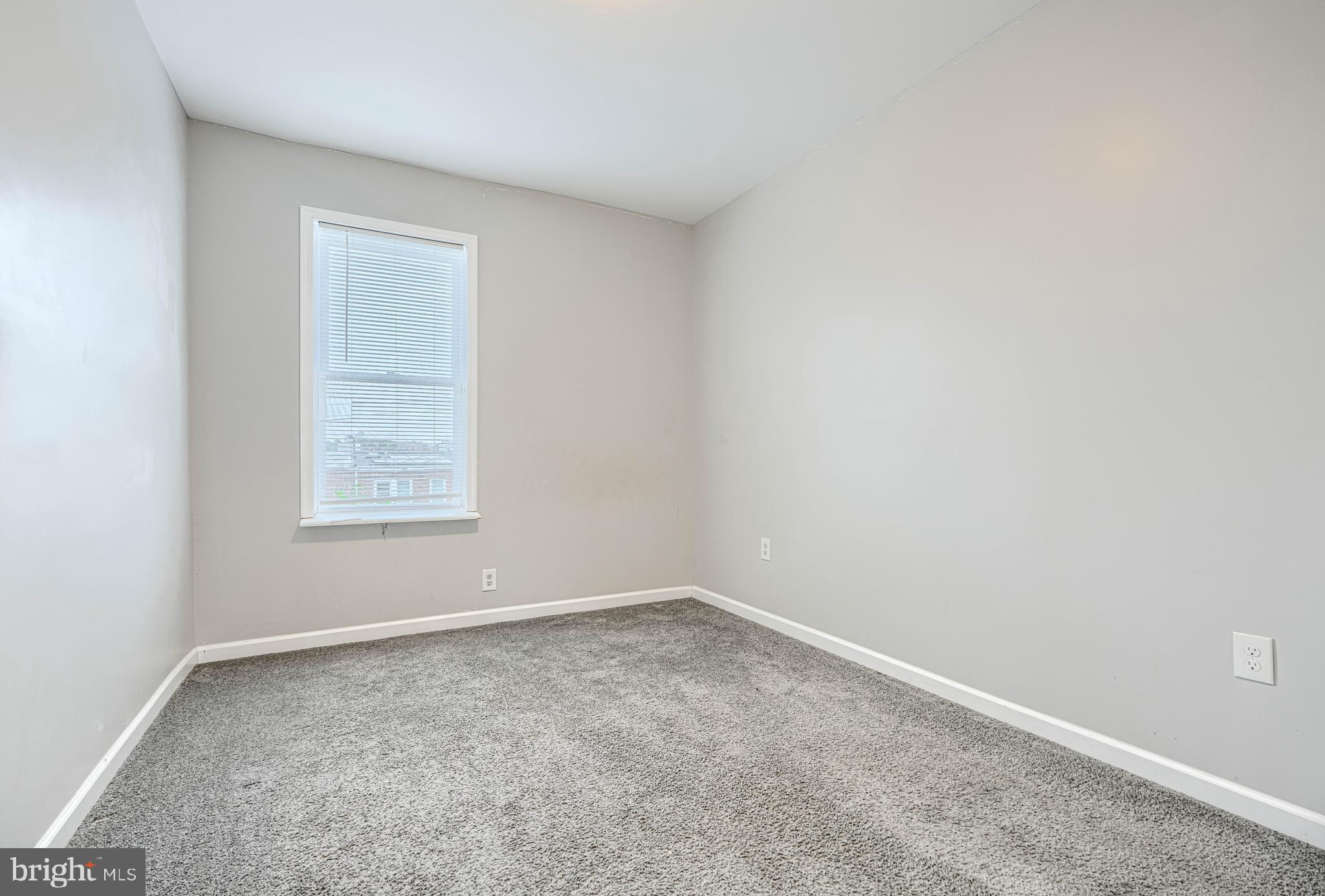 1702 East 32nd Street Baltimore, MD 21218 - Photo 19 of 38 an empty room with a window