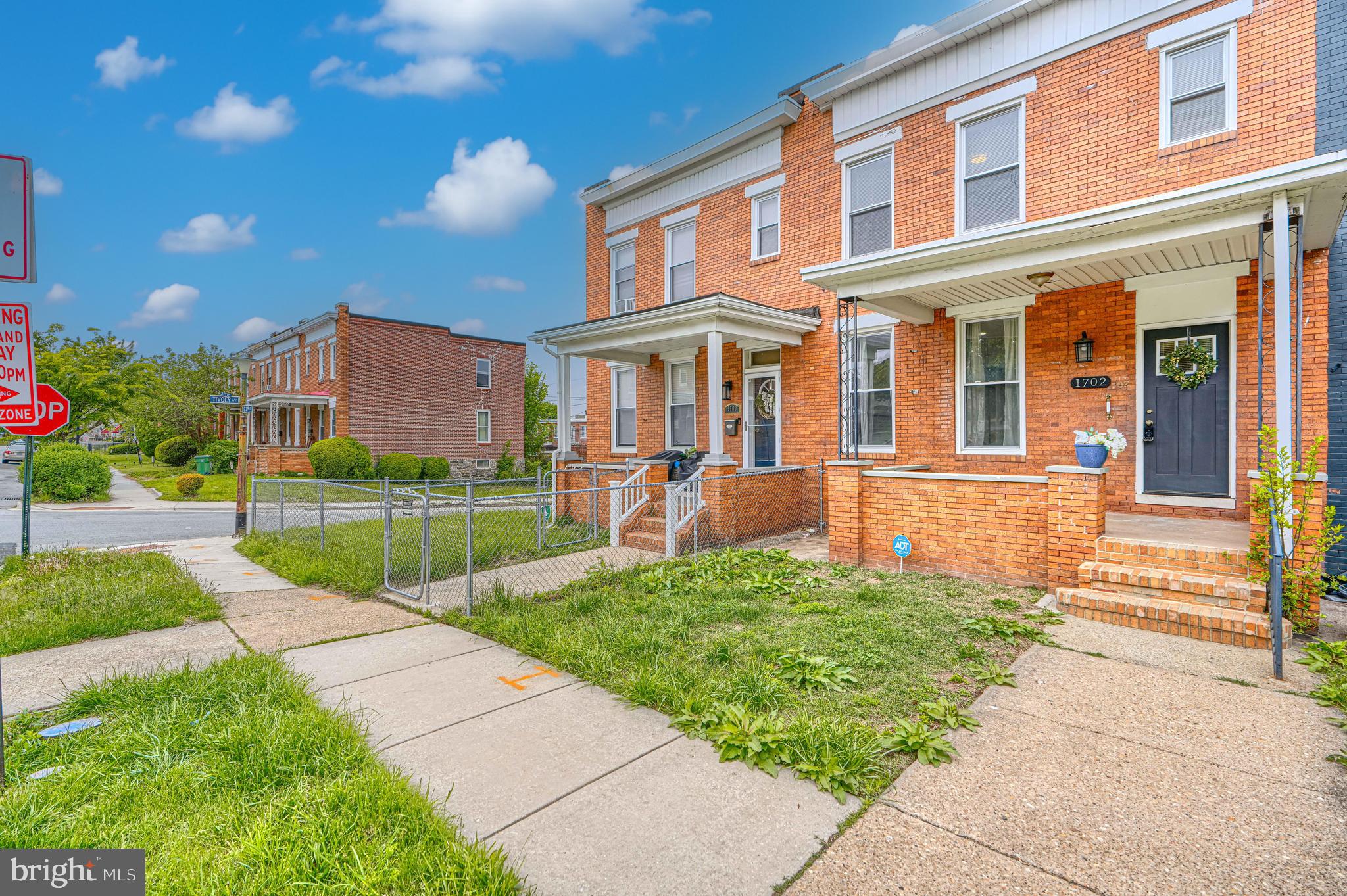 1702 East 32nd Street Baltimore, MD 21218 - Photo 2 of 38 a front view of a house with a yard and table and chairs
