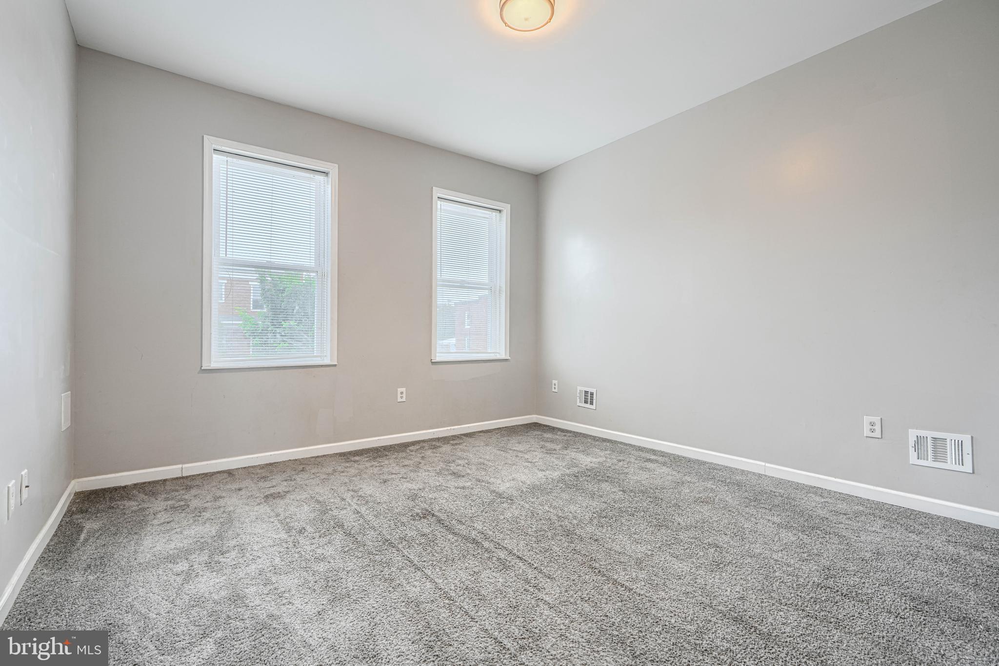 1702 East 32nd Street Baltimore, MD 21218 - Photo 22 of 38 an empty room with windows